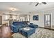 Stylish living room with a plush blue sectional sofa, inviting ottoman, and hardwood floors at 5293 Hearthstone St, Stone Mountain, GA 30083