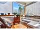 Relaxing covered porch featuring cozy seating, wood floors, and a serene outdoor view at 5293 Hearthstone St, Stone Mountain, GA 30083