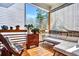 Relaxing screened porch with comfortable seating, potted plants, and wooded views offers a serene outdoor escape at 5293 Hearthstone St, Stone Mountain, GA 30083