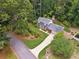 Charming home with manicured lawn and lush landscaping surrounded by mature trees at 626 Cheatham Sw Dr, Marietta, GA 30064