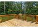 Back deck with wooden railings offers views of the expansive and private backyard at 626 Cheatham Sw Dr, Marietta, GA 30064