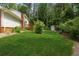 Spacious backyard featuring a storage shed, lush lawn, and mature trees at 626 Cheatham Sw Dr, Marietta, GA 30064
