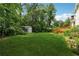 Spacious backyard featuring lush lawn, storage shed, and wooden deck at 626 Cheatham Sw Dr, Marietta, GA 30064