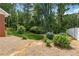 Landscaped backyard featuring lush greenery, mature trees, and privacy fencing at 626 Cheatham Sw Dr, Marietta, GA 30064
