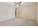Bedroom with neutral walls, carpet, double closet, and a doorway leading to a room painted red at 626 Cheatham Sw Dr, Marietta, GA 30064