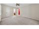 Large bedroom with neutral walls, carpet, and multiple doors, with a ceiling fan providing ventilation at 626 Cheatham Sw Dr, Marietta, GA 30064