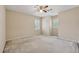 Neutral bedroom features a ceiling fan, carpet, and shuttered windows providing natural light at 626 Cheatham Sw Dr, Marietta, GA 30064