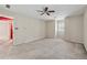 Neutral bedroom features a ceiling fan, carpet, a shuttered window and an entrance leading to another room at 626 Cheatham Sw Dr, Marietta, GA 30064