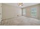 Spacious bedroom with neutral carpet and ample natural light from shuttered windows at 626 Cheatham Sw Dr, Marietta, GA 30064