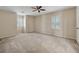 Spacious bedroom with neutral walls, a ceiling fan, and shuttered windows providing natural light at 626 Cheatham Sw Dr, Marietta, GA 30064