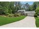Traditional home featuring a large driveway, attached two-car garage, and a lush green lawn at 626 Cheatham Sw Dr, Marietta, GA 30064