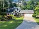Charming two-story home with a well-manicured lawn, mature trees, and a two-car garage at 626 Cheatham Sw Dr, Marietta, GA 30064