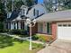 Beautiful front exterior showcasing brick accents, manicured landscaping, and a covered entrance at 626 Cheatham Sw Dr, Marietta, GA 30064
