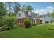 Well-maintained lawn of a brick home with black shutters surrounded by lush greenery at 626 Cheatham Sw Dr, Marietta, GA 30064