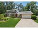 Charming brick home featuring a two-car garage, manicured lawn, and mature trees at 626 Cheatham Sw Dr, Marietta, GA 30064