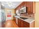 Traditional eat-in kitchen featuring wood cabinets, stainless steel appliances, and beautiful hardwood floors at 626 Cheatham Sw Dr, Marietta, GA 30064