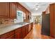 Traditional eat-in kitchen showcasing wood cabinets, modern appliances, and hardwood floors at 626 Cheatham Sw Dr, Marietta, GA 30064