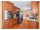 Traditional eat-in kitchen featuring wood cabinets, stainless steel appliances, hardwood floors, and ample storage space at 626 Cheatham Sw Dr, Marietta, GA 30064