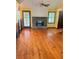 Inviting living room featuring hardwood floors, a stone fireplace, and natural light at 626 Cheatham Sw Dr, Marietta, GA 30064
