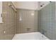 A tub shower combo featuring neutral tile at 626 Cheatham Sw Dr, Marietta, GA 30064