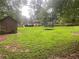 Expansive backyard with a trampoline and storage shed, perfect for outdoor activities at 710 Wind Song Trce, Woodstock, GA 30189