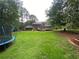 A large backyard features a deck, playset, and ample green space for recreation and relaxation at 710 Wind Song Trce, Woodstock, GA 30189