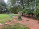 Lush backyard features a swing set, trampoline and storage shed offering space for outdoor enjoyment at 710 Wind Song Trce, Woodstock, GA 30189