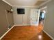 Bright bedroom featuring hardwood floors and a door to another room with natural lighting at 710 Wind Song Trce, Woodstock, GA 30189