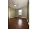 Bedroom with a feature wall, vinyl floors, a ceiling fan, and a window at 710 Wind Song Trce, Woodstock, GA 30189