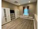 Spacious bedroom with modern flooring and built in closet and shelving with neutral color palette at 710 Wind Song Trce, Woodstock, GA 30189