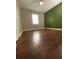 Bedroom with a feature wall, vinyl floors, a ceiling fan, and a window at 710 Wind Song Trce, Woodstock, GA 30189