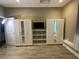 Bedroom featuring modern flooring and built in closet and shelving with neutral color palette at 710 Wind Song Trce, Woodstock, GA 30189