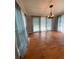 Open dining room with hardwood floors, a modern chandelier, and access to the backyard through sliding doors at 710 Wind Song Trce, Woodstock, GA 30189