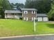 Charming two-story home with a well-manicured lawn and three-car garage at 710 Wind Song Trce, Woodstock, GA 30189