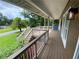 The home's front porch offers a cozy space with stylish lighting and a charming view at 710 Wind Song Trce, Woodstock, GA 30189