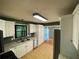 Stylish kitchen with white cabinets, stainless steel appliances, and views into adjoining room at 710 Wind Song Trce, Woodstock, GA 30189
