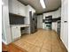 Well-lit kitchen features white cabinets, stainless steel appliances, and a built-in desk area at 710 Wind Song Trce, Woodstock, GA 30189