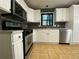 This kitchen is complete with white cabinets and a stainless steel oven and cooktop at 710 Wind Song Trce, Woodstock, GA 30189