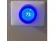 Modern thermostat with digital display set to 73 degrees, ensuring a comfortable home environment at 710 Wind Song Trce, Woodstock, GA 30189