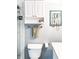 Bathroom features white cabinets, an updated toilet, and a decorative jewelry display at 800 Peachtree Ne St # 1319, Atlanta, GA 30308