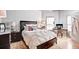 Cozy bedroom with a stylish accent furniture, a large window, and hardwood floors at 800 Peachtree Ne St # 1319, Atlanta, GA 30308