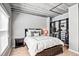 Bedroom featuring wood floors, large bed with decorative pillows, open closet with shelving and hanging storage at 800 Peachtree Ne St # 1319, Atlanta, GA 30308