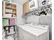 Laundry room with front loading washer and dryer, wire shelving, and ample storage space at 800 Peachtree Ne St # 1319, Atlanta, GA 30308