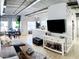 Bright living room features a dining area, hardwood floors, exposed pipes, and natural light from large windows at 800 Peachtree Ne St # 1319, Atlanta, GA 30308