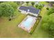 Aerial view of a well-maintained home with a backyard featuring a sparkling pool and lush landscaping at 256 Teresa Ln, Loganville, GA 30052