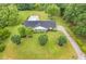 Aerial view of a home showcasing a well-maintained lawn, mature trees, and a pool at 256 Teresa Ln, Loganville, GA 30052