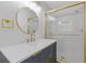 Modern bathroom showcasing vanity with white countertop, new lighting, and shower with gold trim at 256 Teresa Ln, Loganville, GA 30052