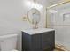 Modern bathroom featuring new vanity with a round mirror and a glass enclosed shower with gold trim at 256 Teresa Ln, Loganville, GA 30052