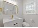 Modern bathroom with a white vanity, brushed gold fixtures and subway tiled walls at 256 Teresa Ln, Loganville, GA 30052
