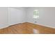 Clean bedroom featuring hardwood floors, a closet, and natural light at 256 Teresa Ln, Loganville, GA 30052